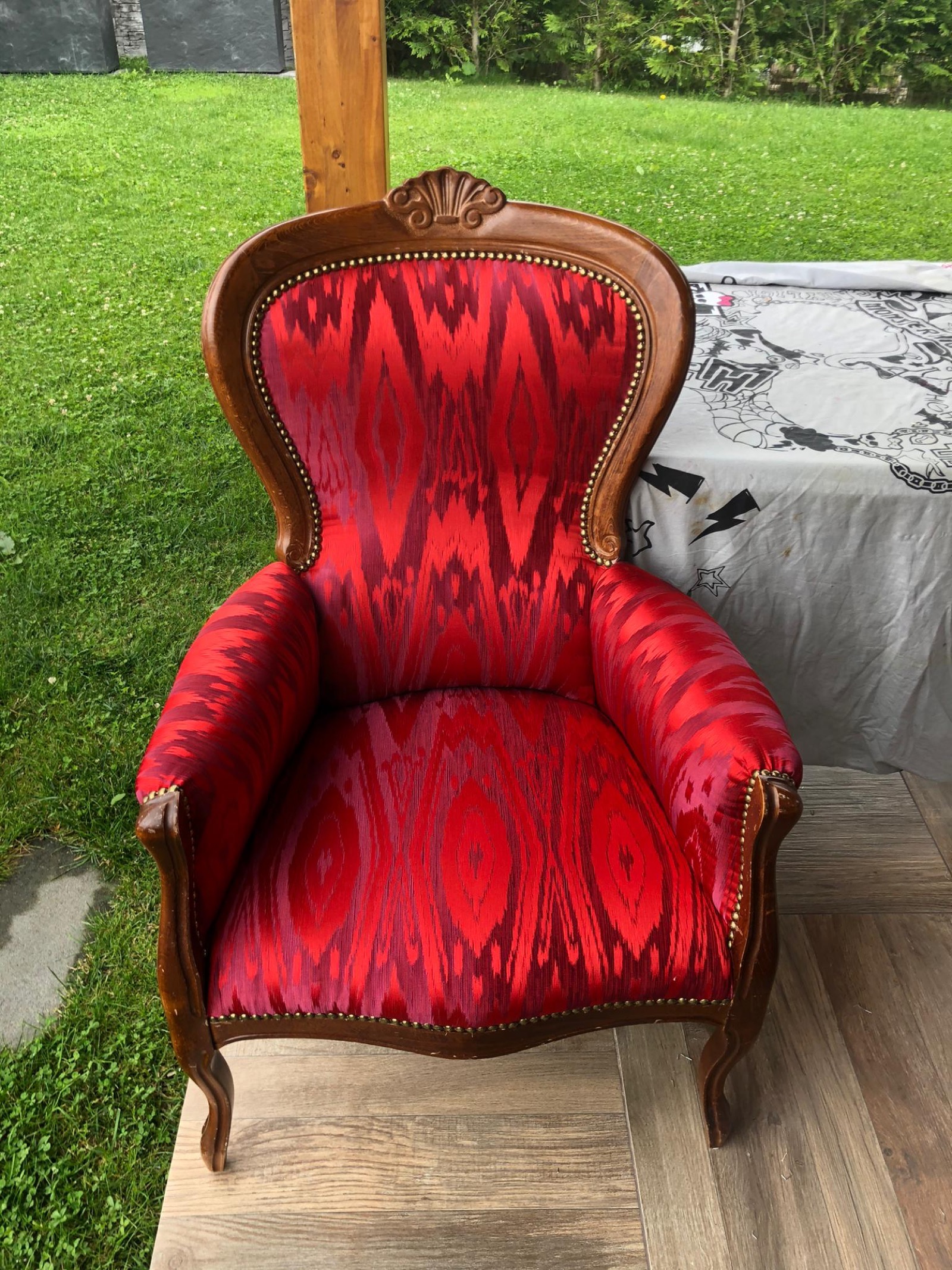 Fauteuil Voltaire restauré en tissu rouge à motifs